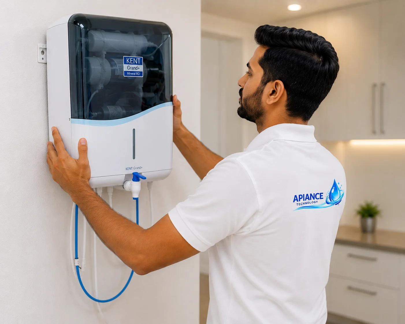 Professional technician installing a wall-mounted RO water purifier at a home in Faridabad while wearing an Apiance Technology uniform.